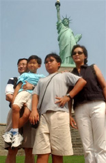 Asian American family in front of Statue of Liberty